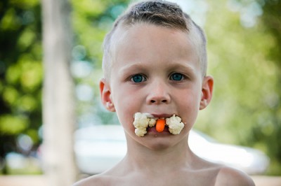 boy with carrots in mouth