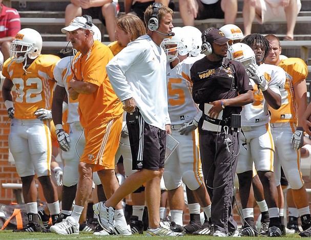 Tennessee head coach Lane Kiffin, center, and his father and defensive coordinator, Monte Kiffin, walk the sidelines during a scrimmage on Aug. 22.